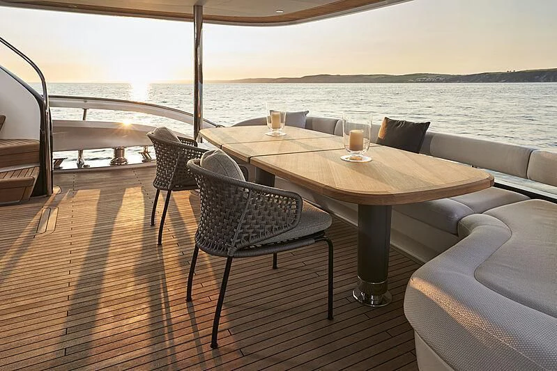 a table and chairs on a deck aboard TATIANA Yacht for Sale