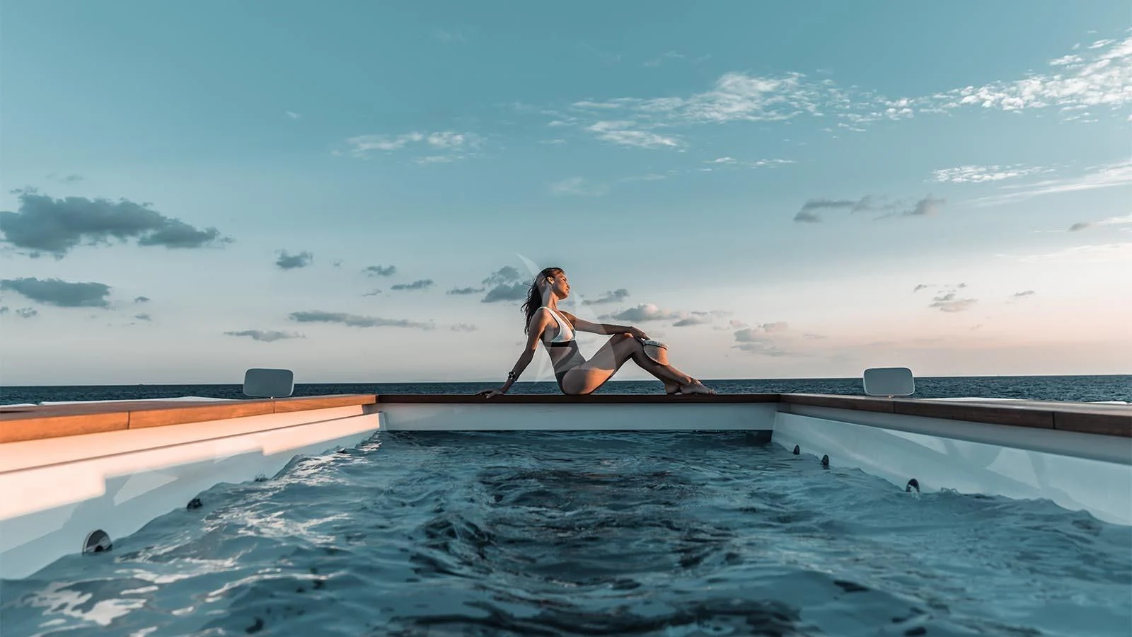 a man sitting on a ledge aboard TATIANA Yacht for Sale