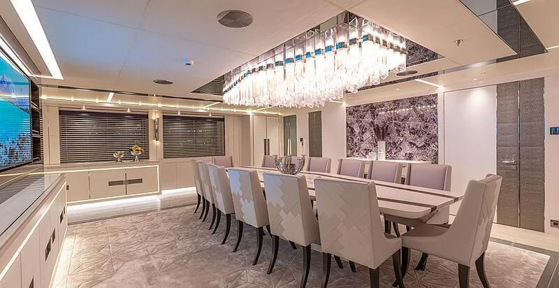 a large room with a table and chairs aboard TATIANA Yacht for Sale
