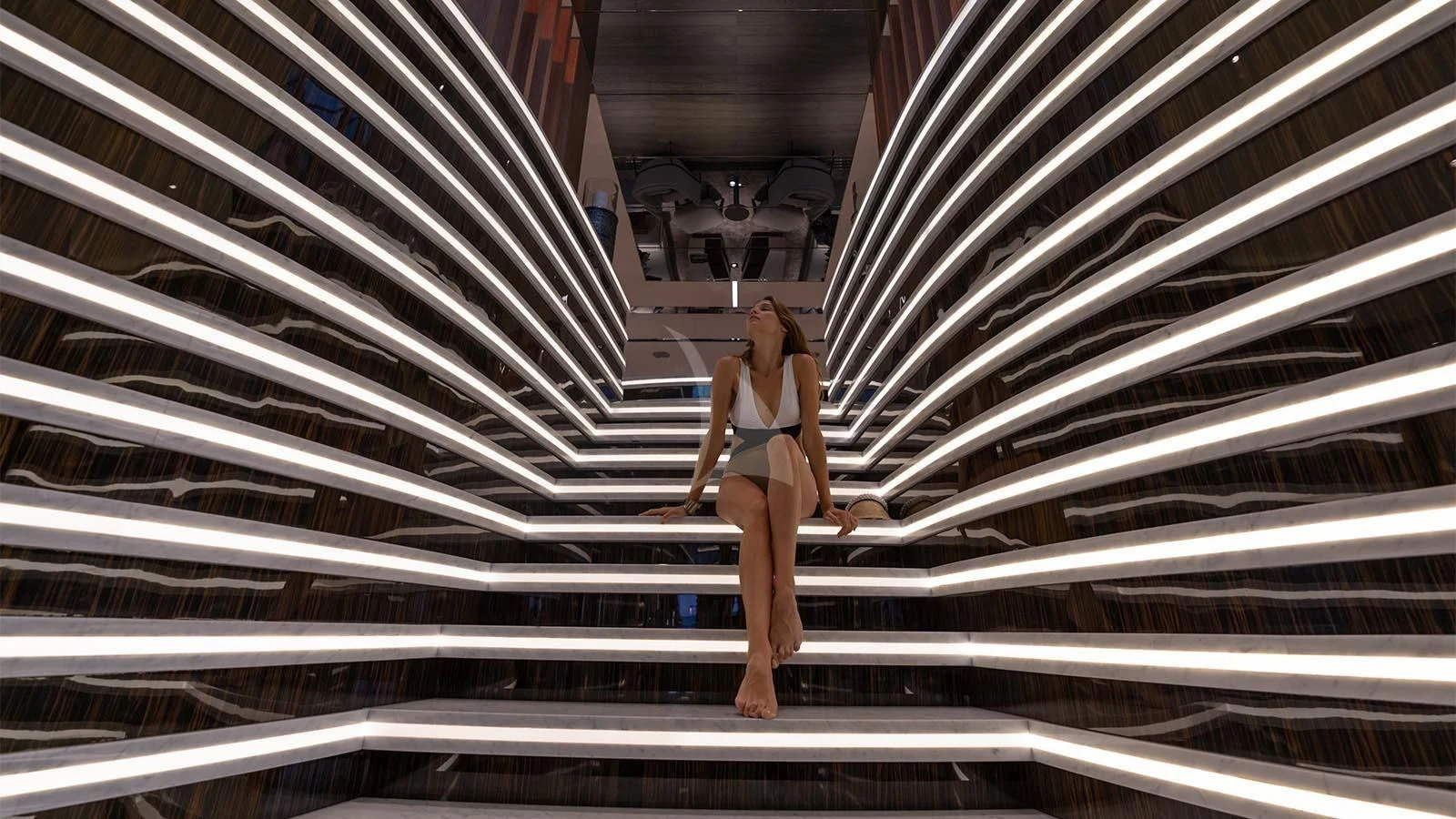 a person in a bikini walking up a flight of stairs aboard TATIANA Yacht for Sale