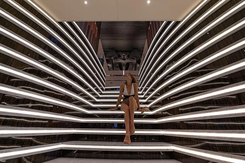 a person in a bikini walking up a flight of stairs aboard TATIANA Yacht for Sale