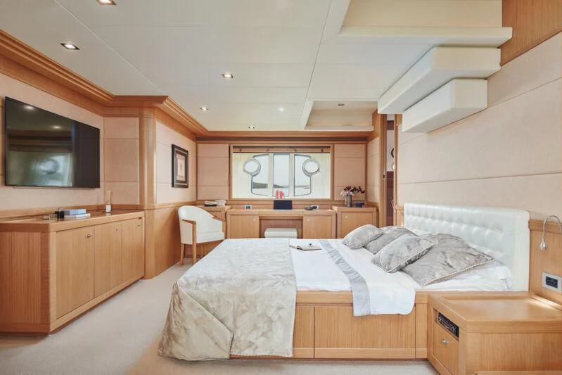 a bedroom with a bed and a desk aboard FRIEND'S BOAT Yacht for Charter