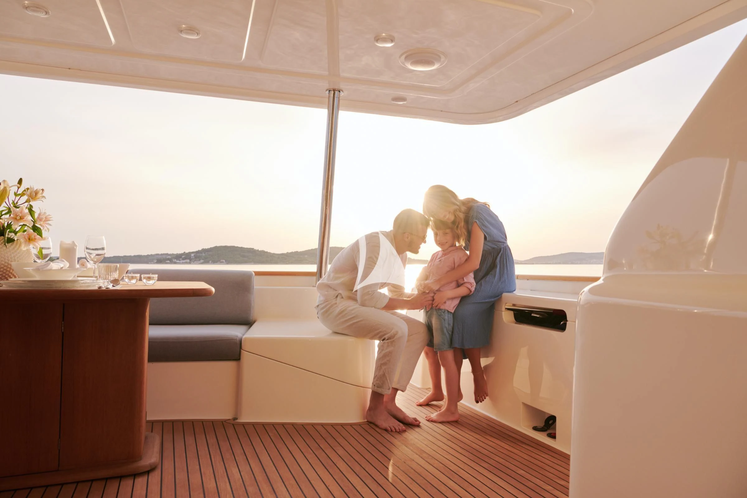 a man and a woman kissing on a couch aboard FRIEND'S BOAT Yacht for Charter