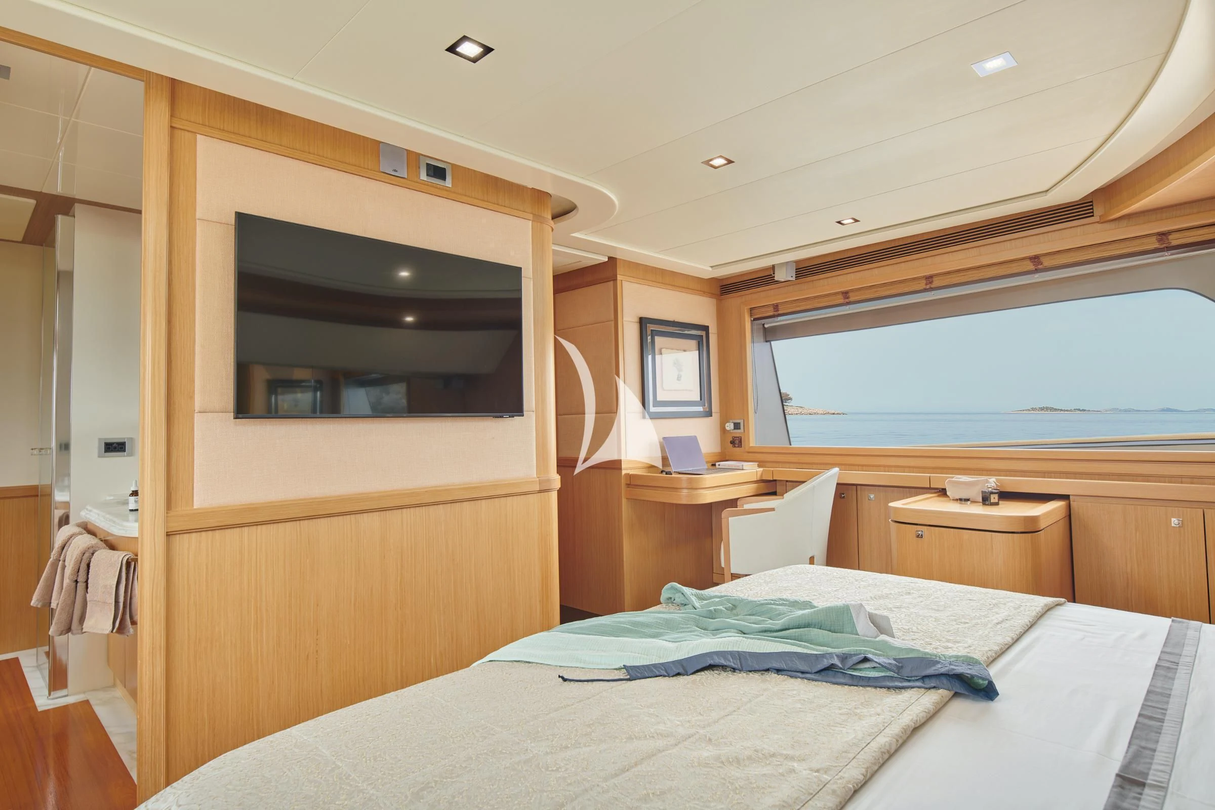 a bed with a television on the wall aboard FRIEND'S BOAT Yacht for Charter