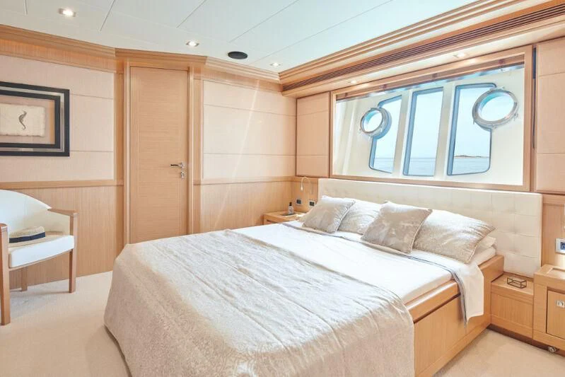 a room with a bed and a window aboard FRIEND'S BOAT Yacht for Charter