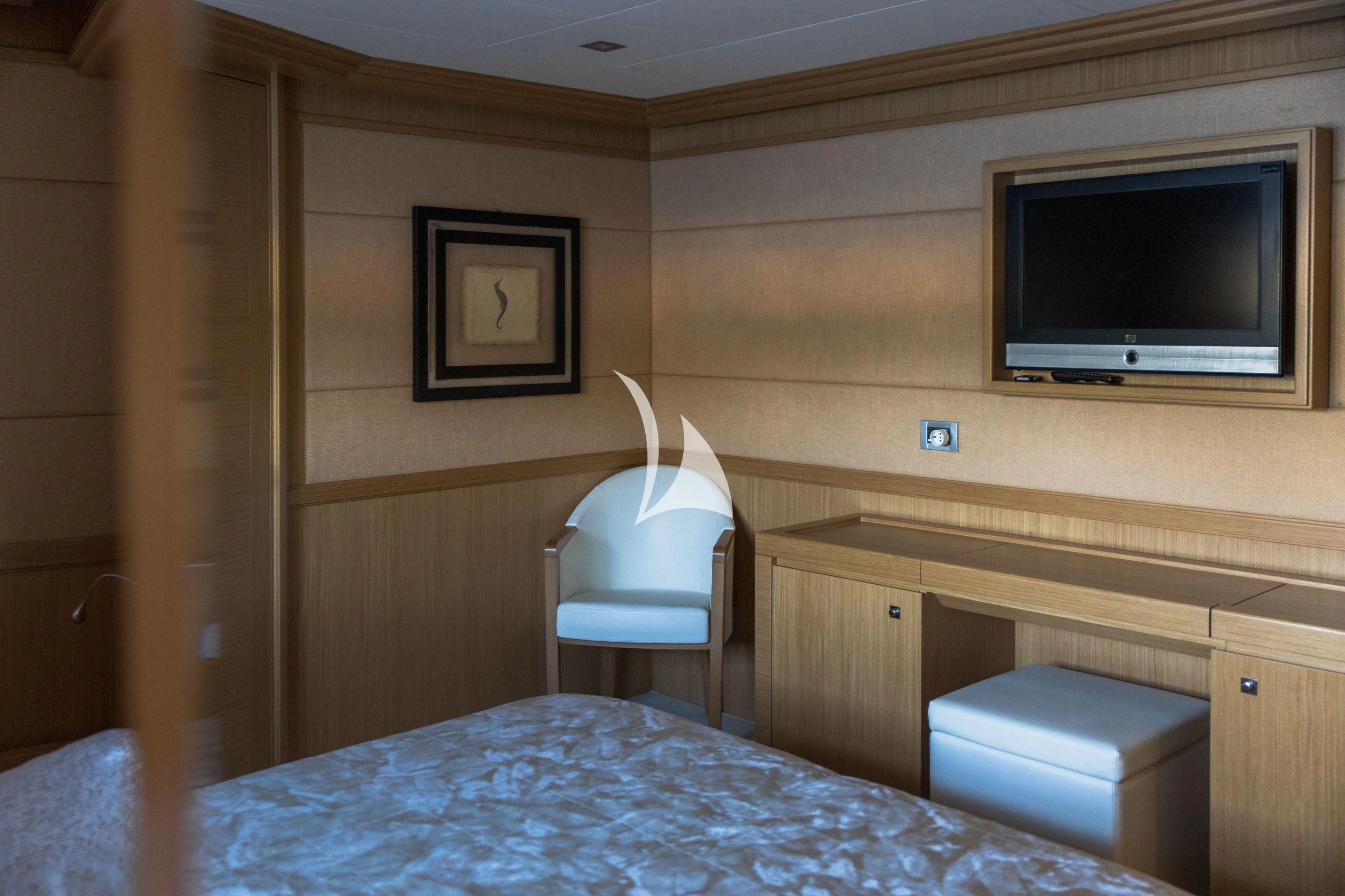 a bed with a television on the wall aboard FRIEND'S BOAT Yacht for Charter