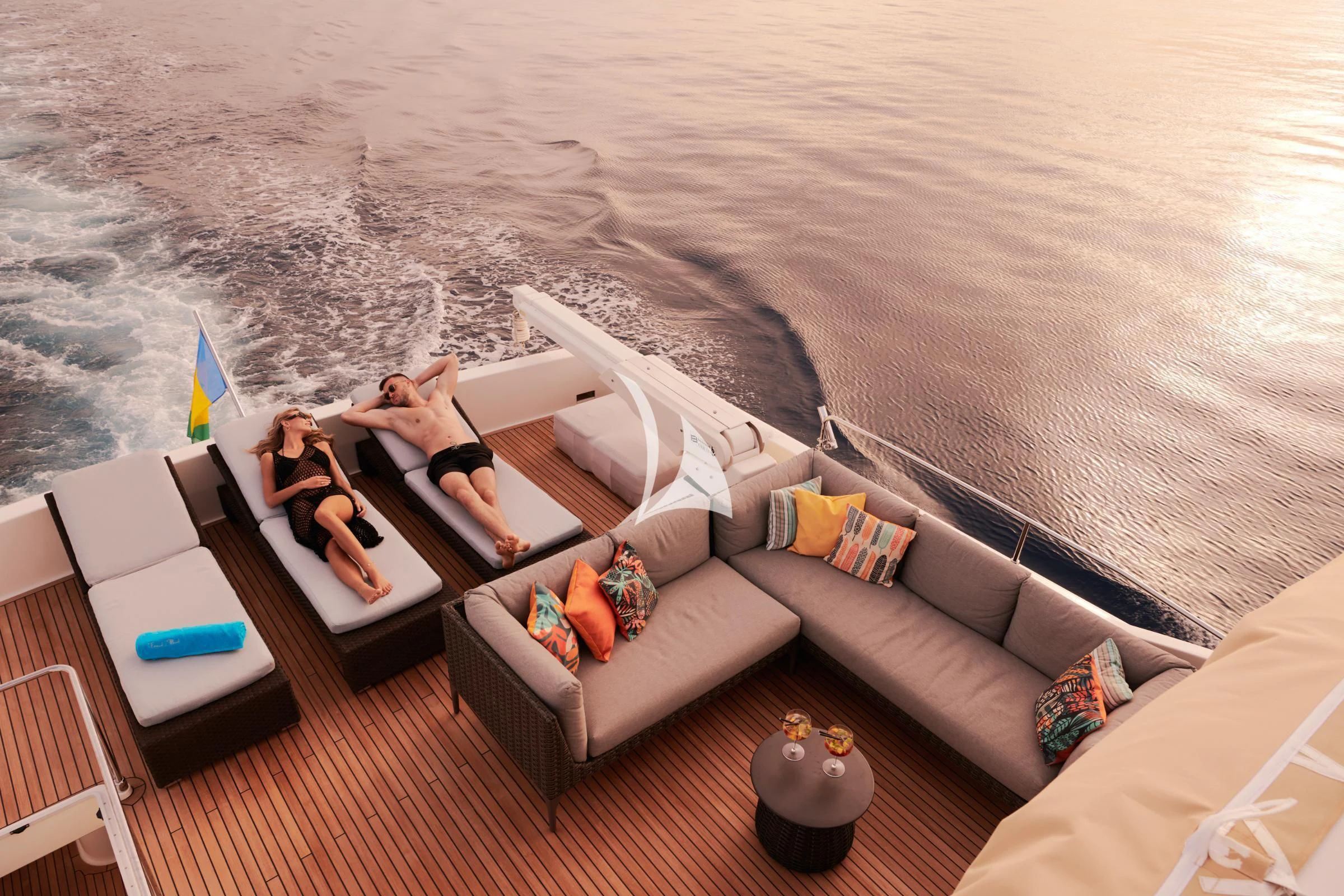 a person sitting on a couch on a beach aboard FRIEND'S BOAT Yacht for Charter