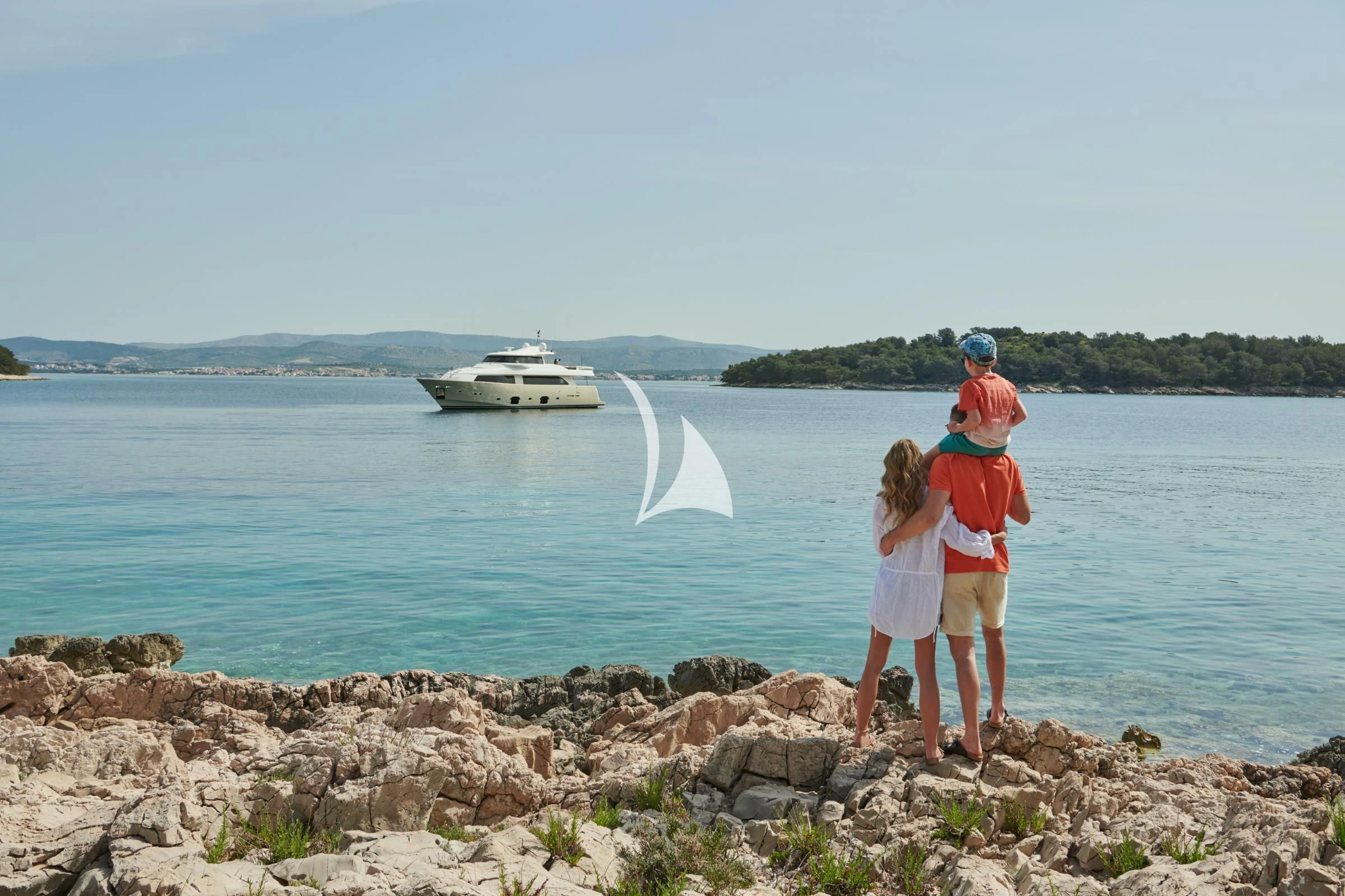 a group of people standing on rocks by a body of water aboard FRIEND'S BOAT Yacht for Charter