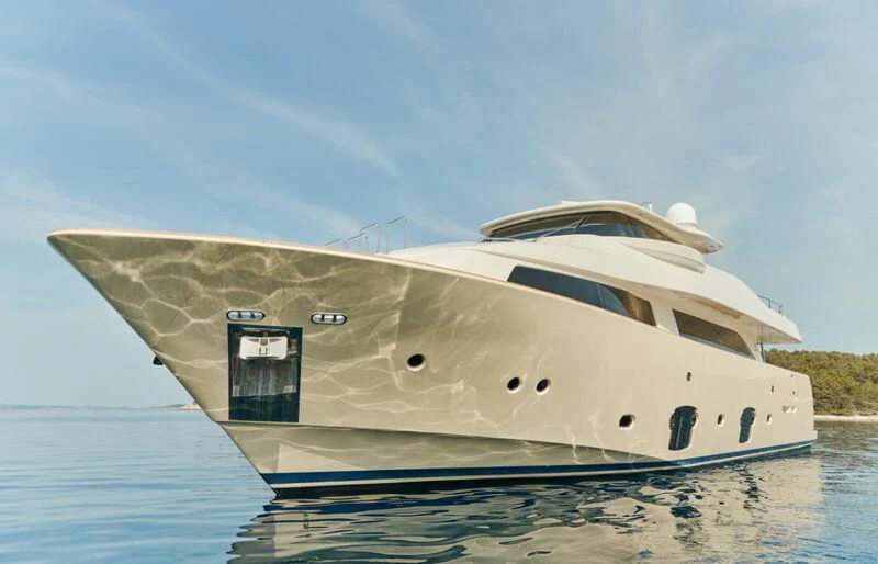 a large white boat on the water aboard FRIEND'S BOAT Yacht for Charter