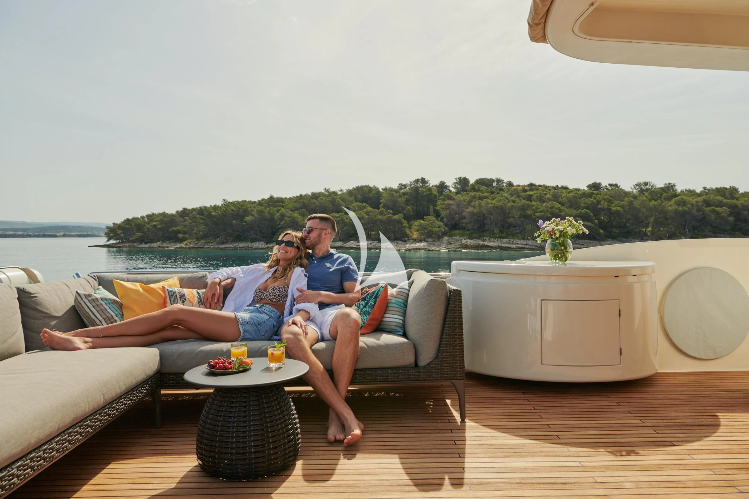a family sitting on a couch aboard FRIEND'S BOAT Yacht for Charter