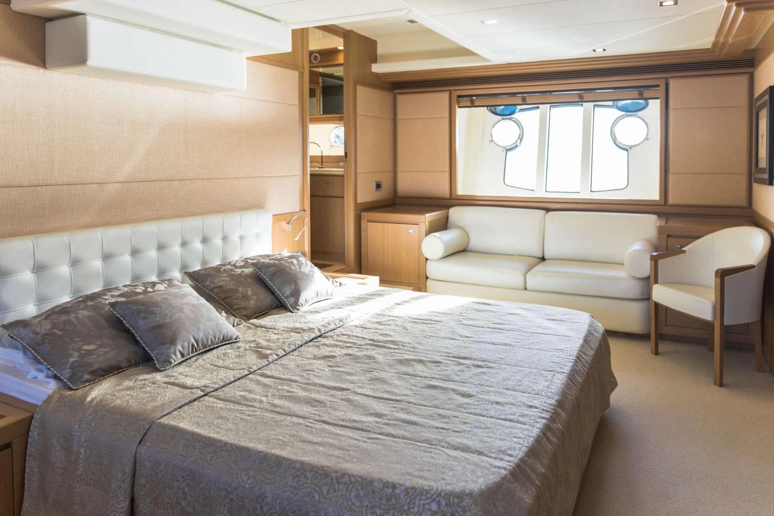 a room with a bed and a chair aboard FRIEND'S BOAT Yacht for Charter