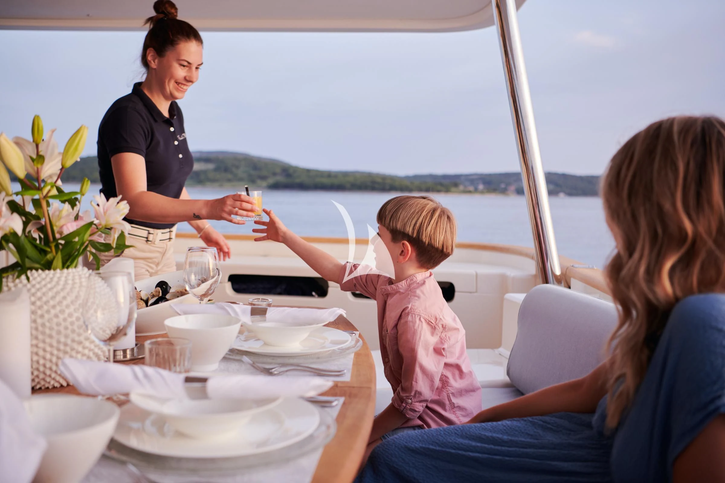 a family having a meal on a boat aboard FRIEND'S BOAT Yacht for Charter