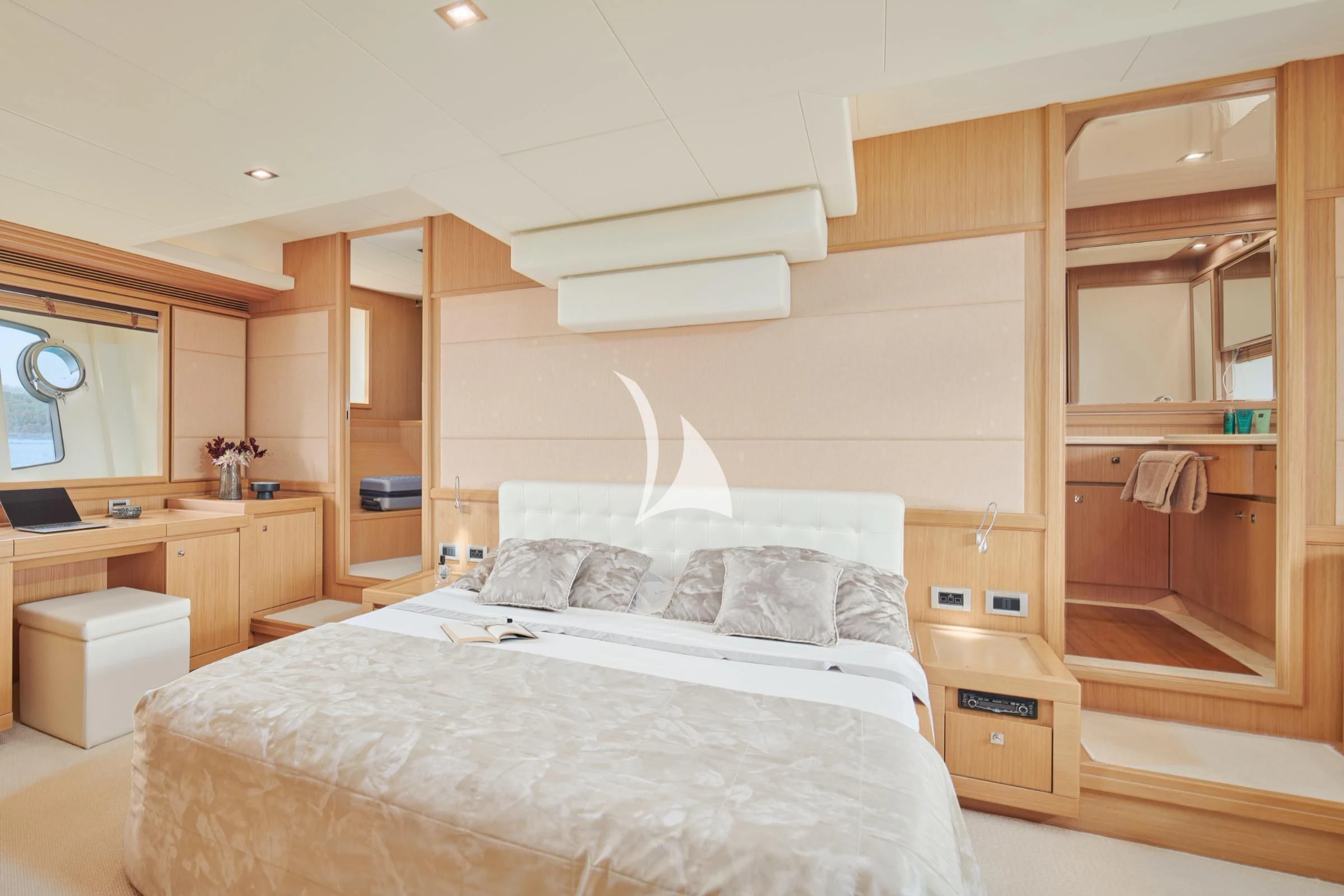a bedroom with a bed and a desk aboard FRIEND'S BOAT Yacht for Charter