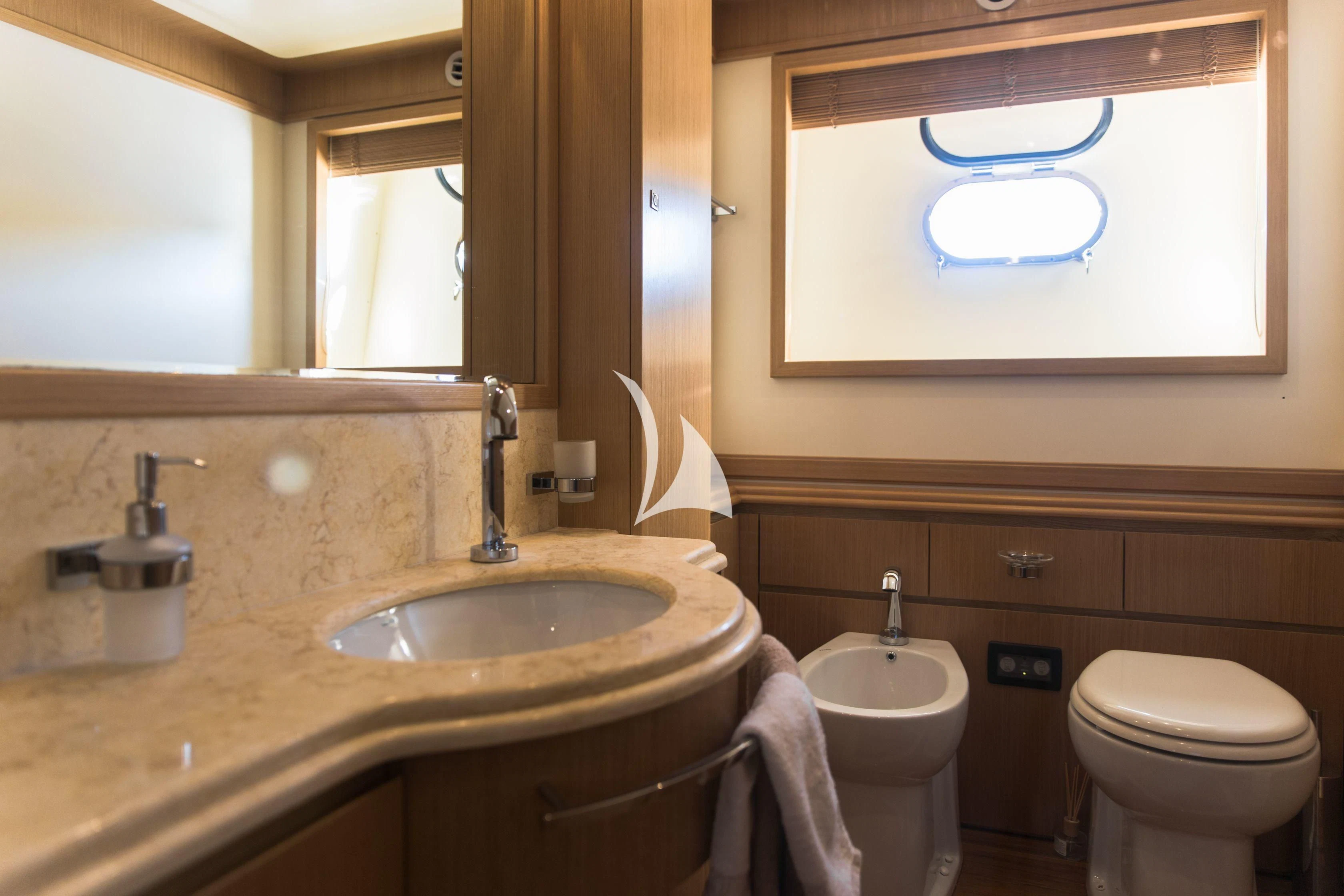 a bathroom with a sink toilet and a mirror aboard FRIEND'S BOAT Yacht for Charter