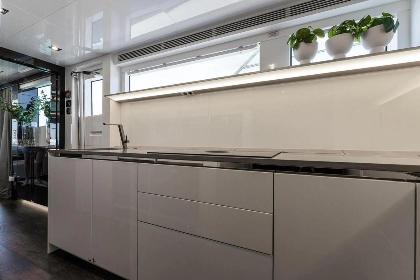 a kitchen with white cabinets aboard KNEAD IT Yacht for Sale