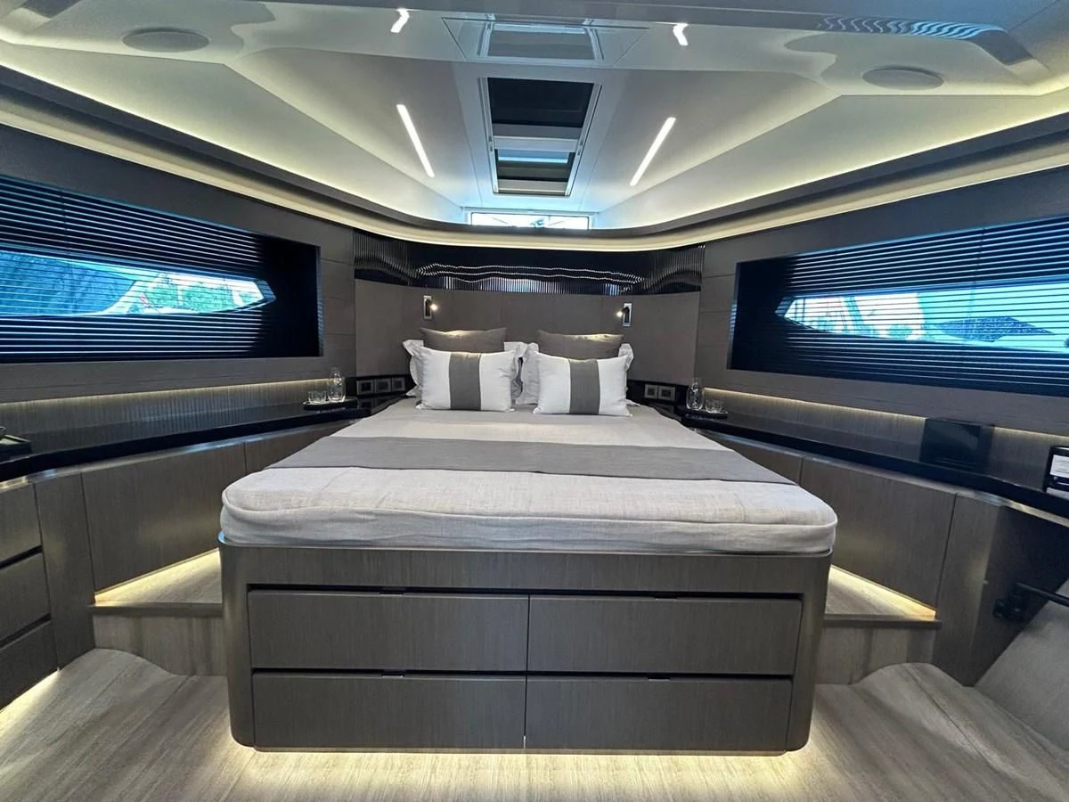 a room with a bed and a television aboard KNEAD IT Yacht for Sale