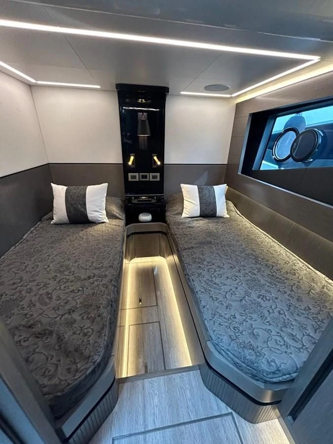 a room with a bed and a television aboard KNEAD IT Yacht for Sale