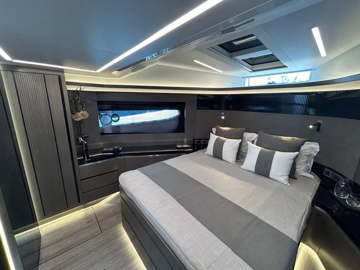 a modern looking bedroom with a large bed aboard KNEAD IT Yacht for Sale