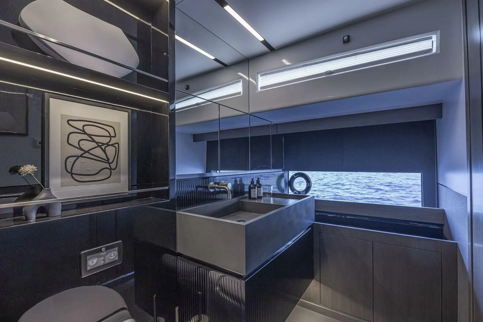 a bathroom with a sink and a large window aboard KNEAD IT Yacht for Sale