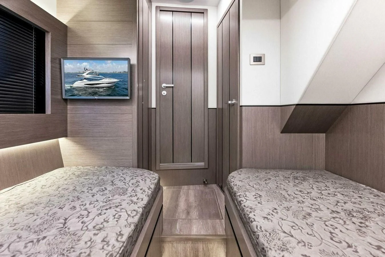 a bedroom with a bed and a television aboard KNEAD IT Yacht for Sale