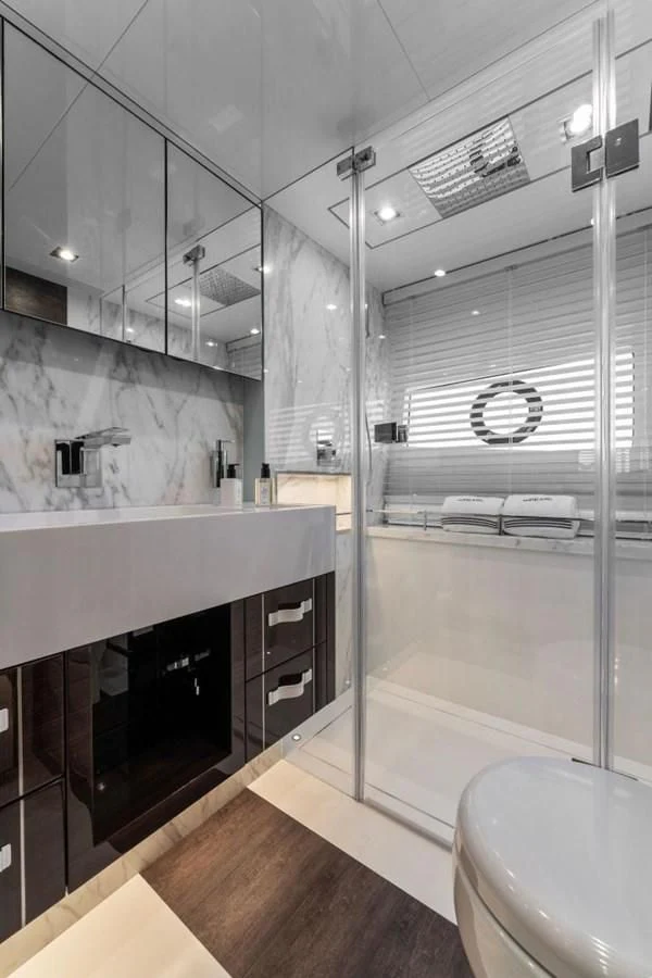 a bathroom with a glass shower aboard KNEAD IT Yacht for Sale