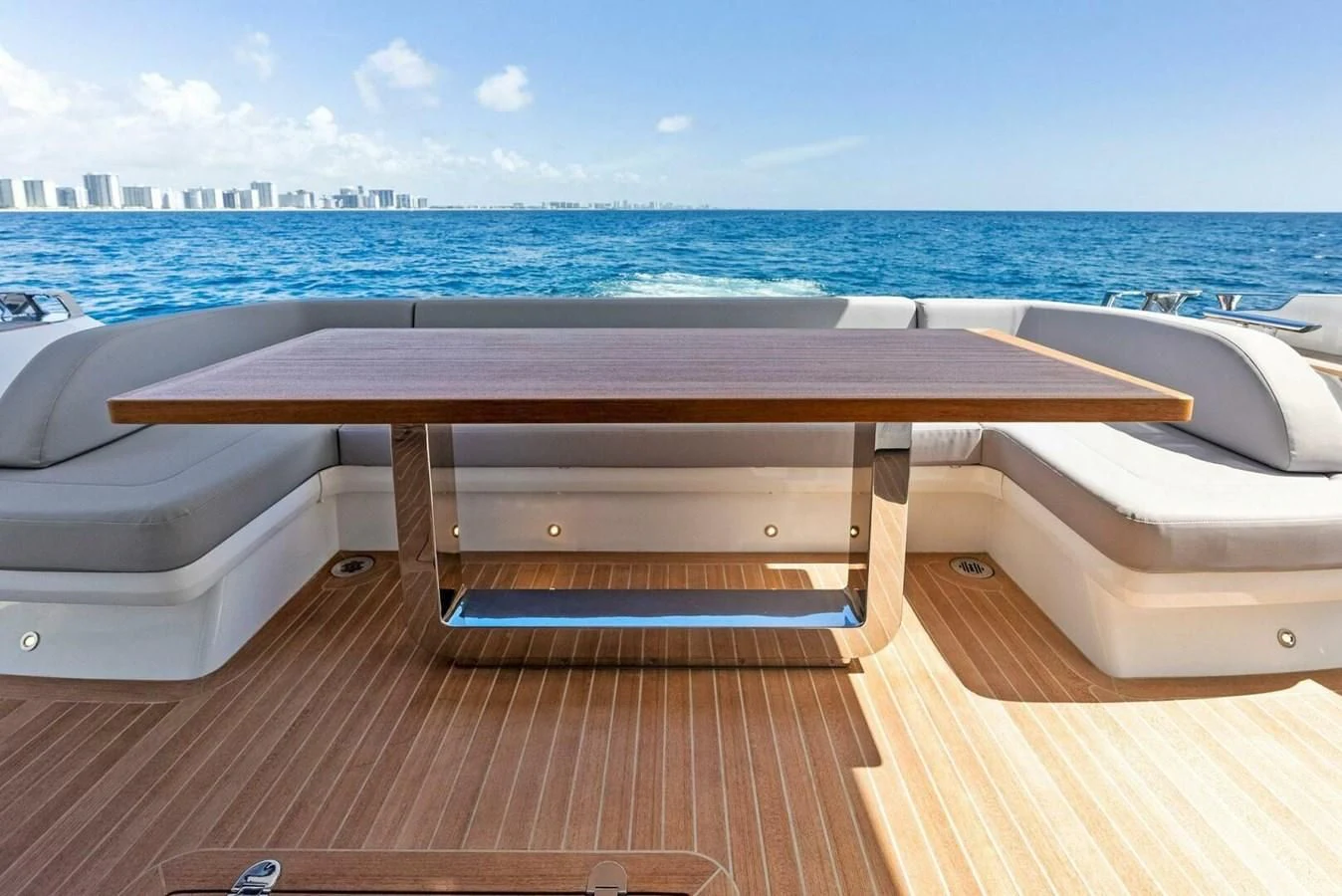 a table on a deck overlooking a body of water aboard KNEAD IT Yacht for Sale