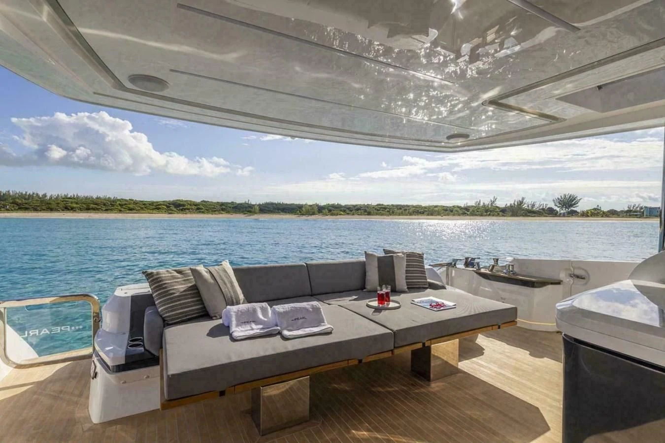 a table on a deck overlooking a body of water aboard KNEAD IT Yacht for Sale