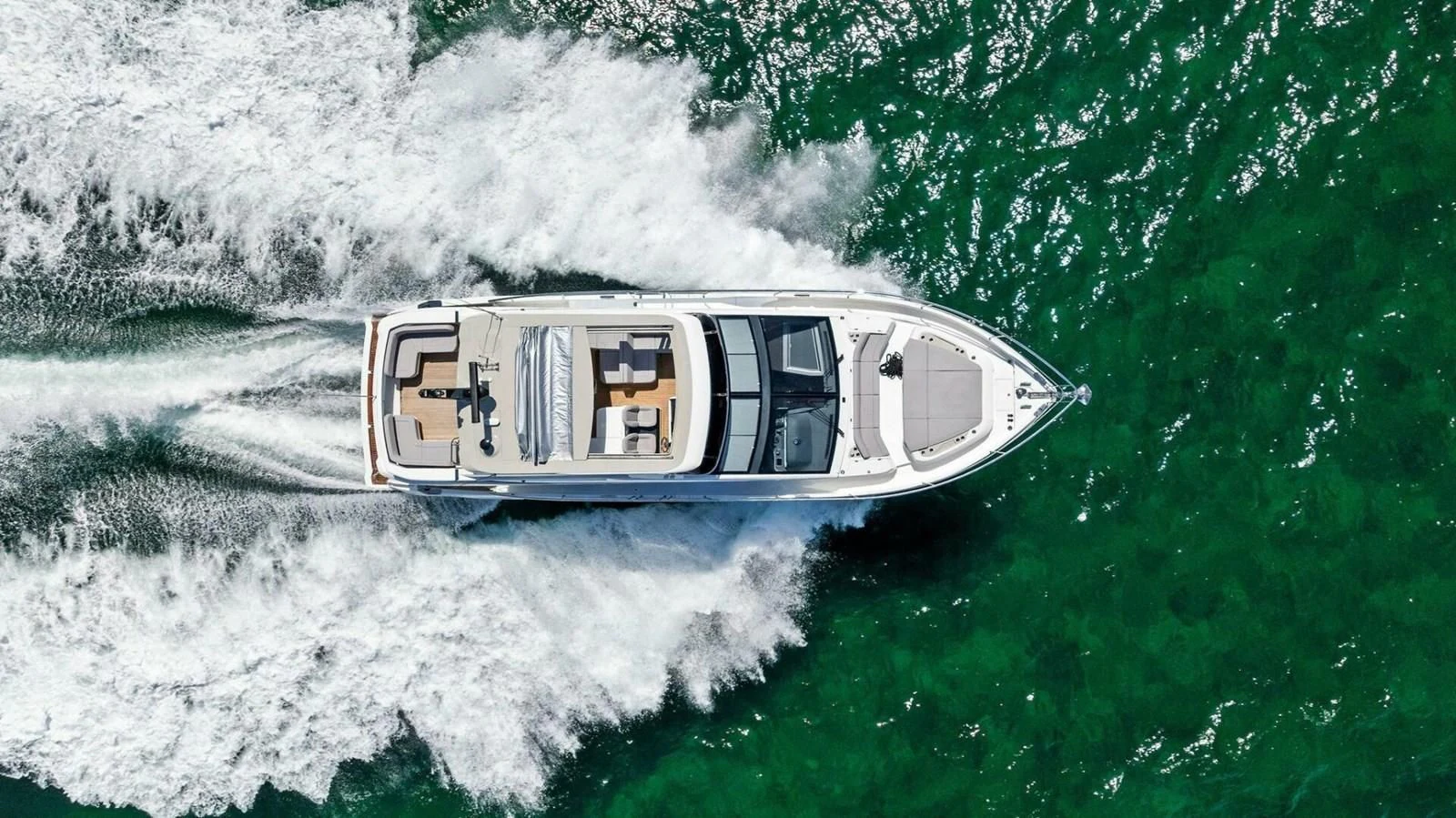 a helicopter flying over a body of water aboard KNEAD IT Yacht for Sale