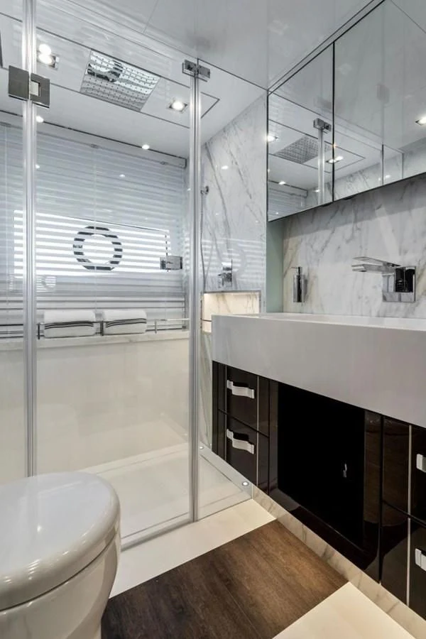 a bathroom with a glass shower aboard KNEAD IT Yacht for Sale