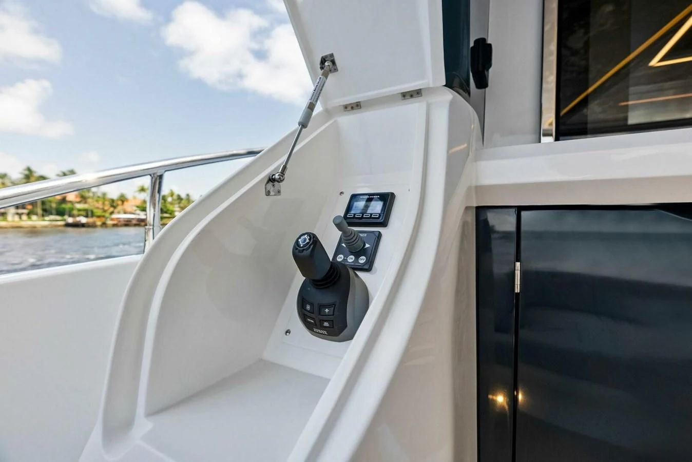a white boat with a steering wheel aboard KNEAD IT Yacht for Sale