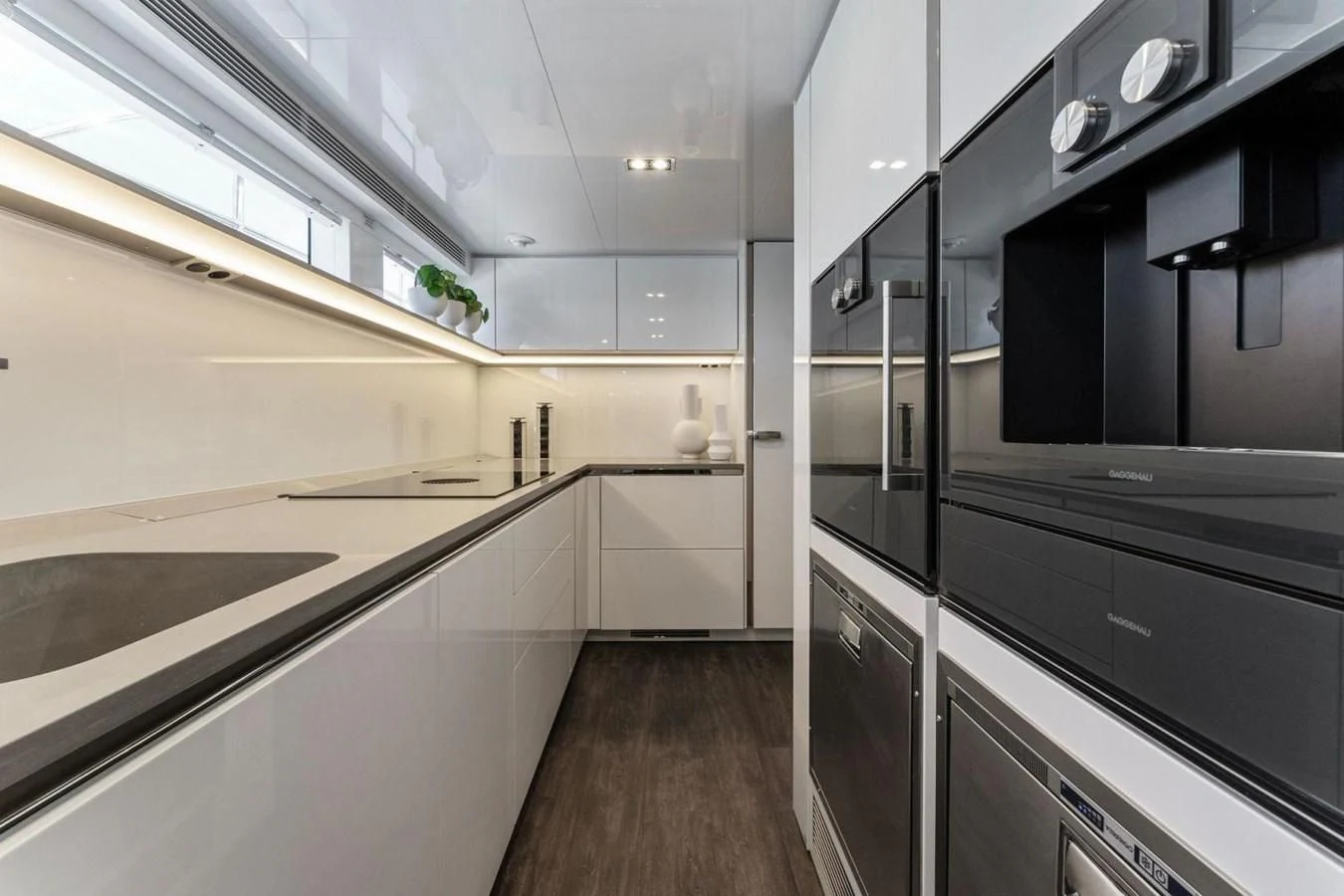 a kitchen with black cabinets aboard KNEAD IT Yacht for Sale