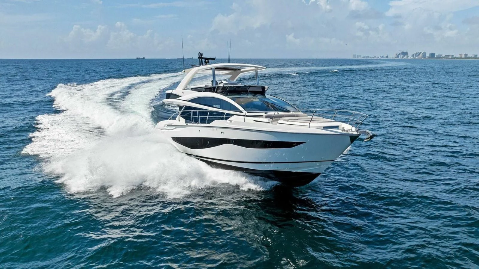 a white boat on the water aboard KNEAD IT Yacht for Sale