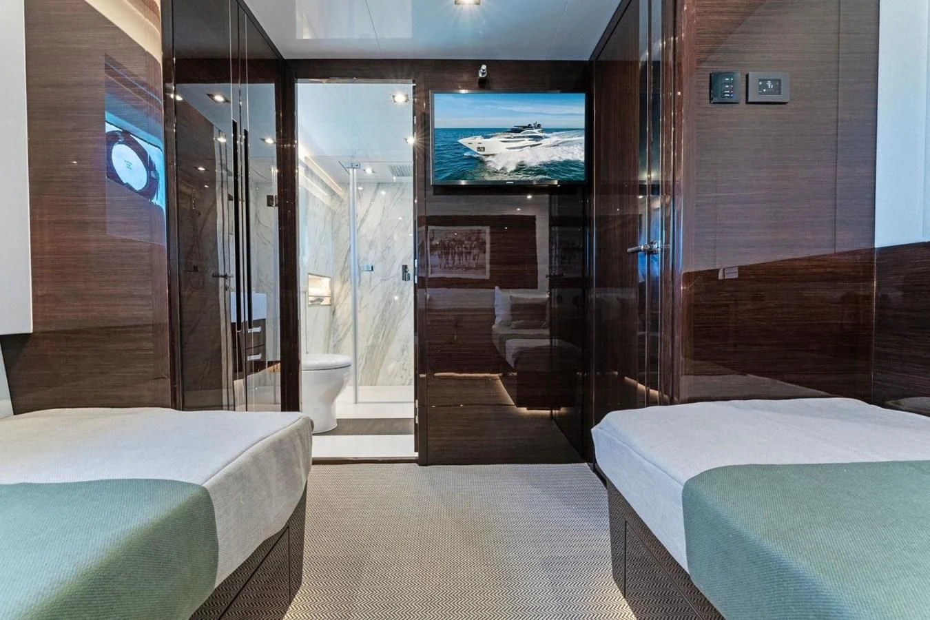 a room with a bed and a tv on the wall aboard KNEAD IT Yacht for Sale