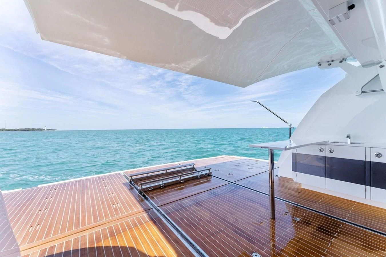 a deck with a view of the ocean and the ocean aboard KNEAD IT Yacht for Sale