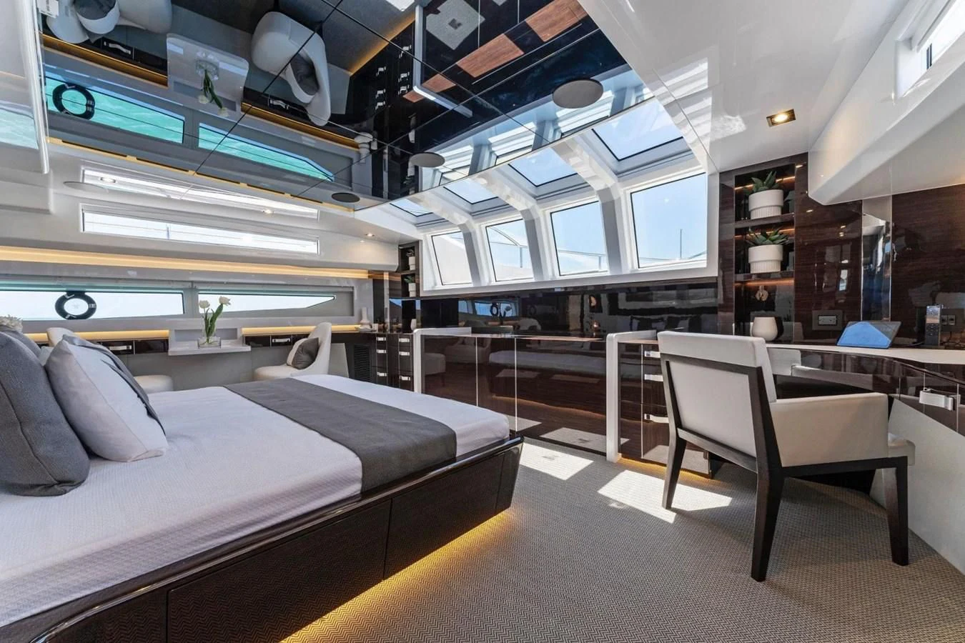 a room with a bed and desk aboard KNEAD IT Yacht for Sale