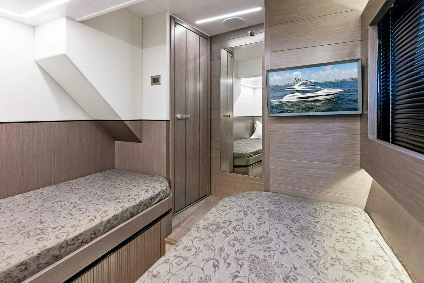 a room with a bed and a television aboard KNEAD IT Yacht for Sale