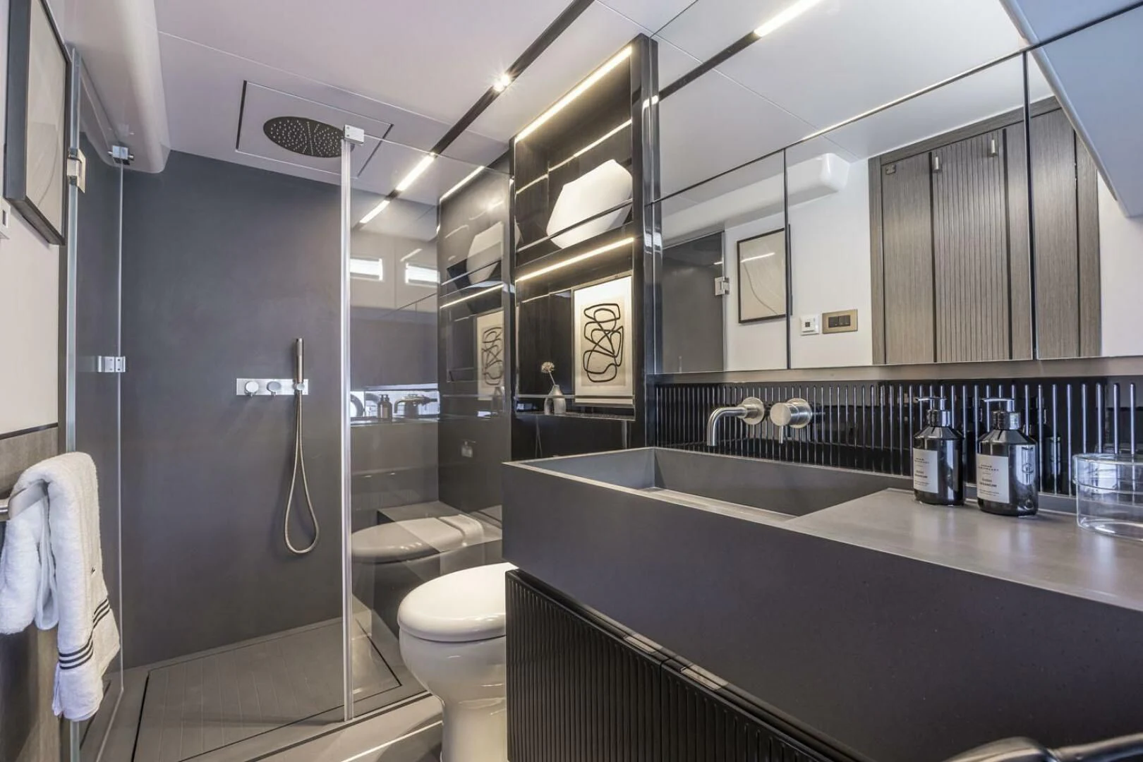 a bathroom with a glass shower aboard KNEAD IT Yacht for Sale