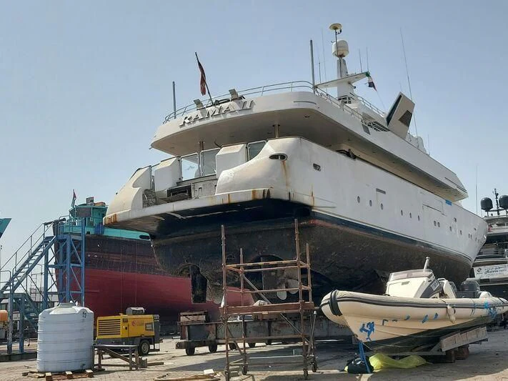 a large white ship docked aboard RAMA II Yacht for Sale