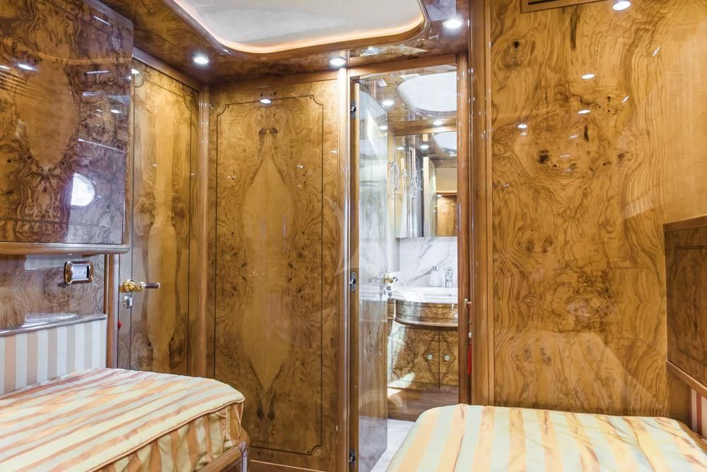 a room with a bed and a mirror aboard HEMERA CUARTA Yacht for Sale