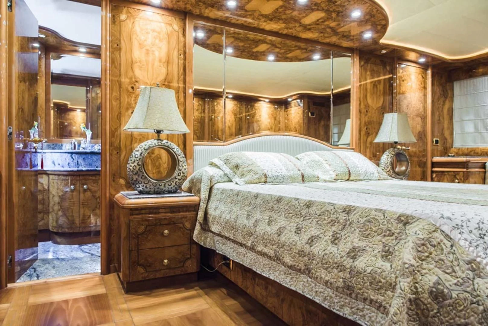 a bed with a lamp on it aboard HEMERA CUARTA Yacht for Sale