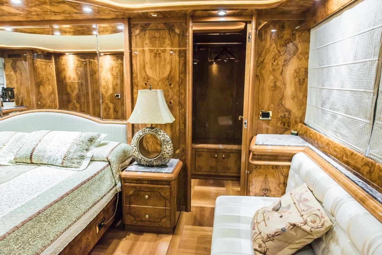 a room with a bed and a lamp aboard HEMERA CUARTA Yacht for Sale