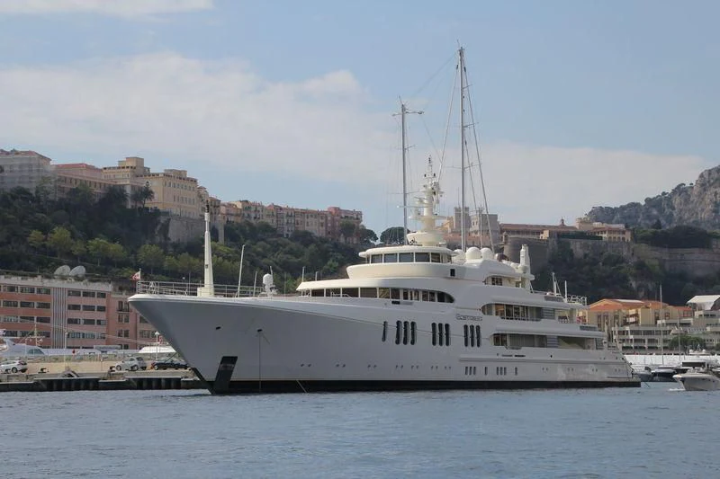 a large white boat in a harbor aboard ECSTASEA Yacht for Sale