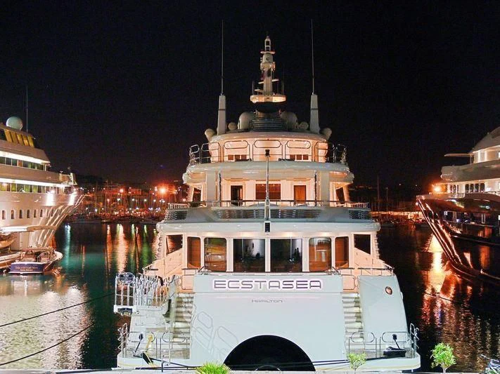 a white building with a dome and a tower with a clock on it aboard ECSTASEA Yacht for Sale