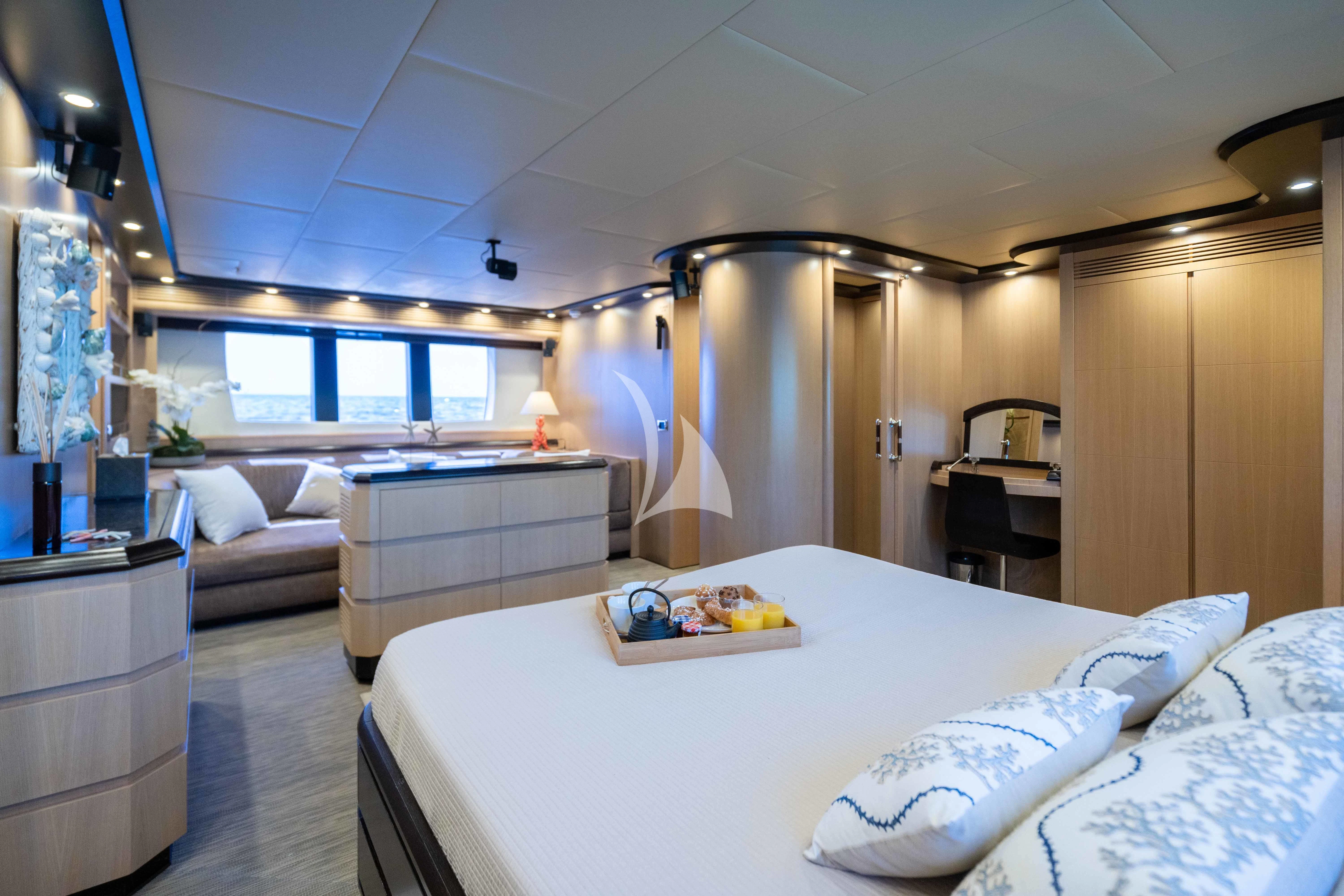 a large bedroom with a large bed aboard DOLCE VITA IV Yacht for Sale