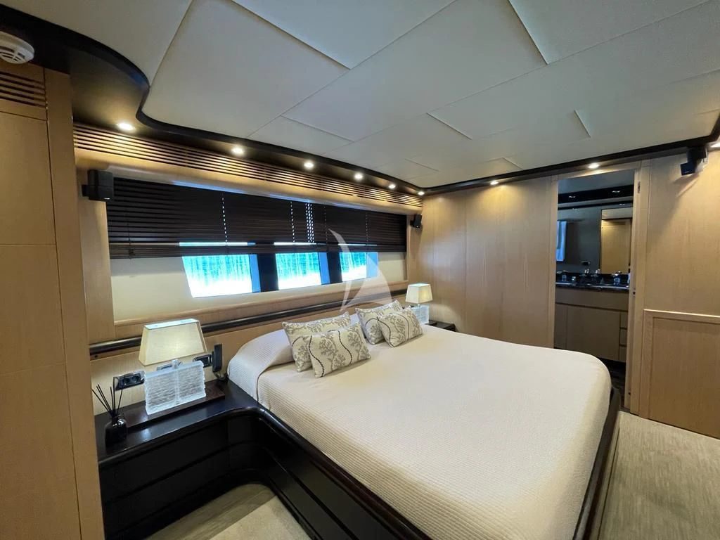 a room with a bed and a window aboard DOLCE VITA IV Yacht for Sale