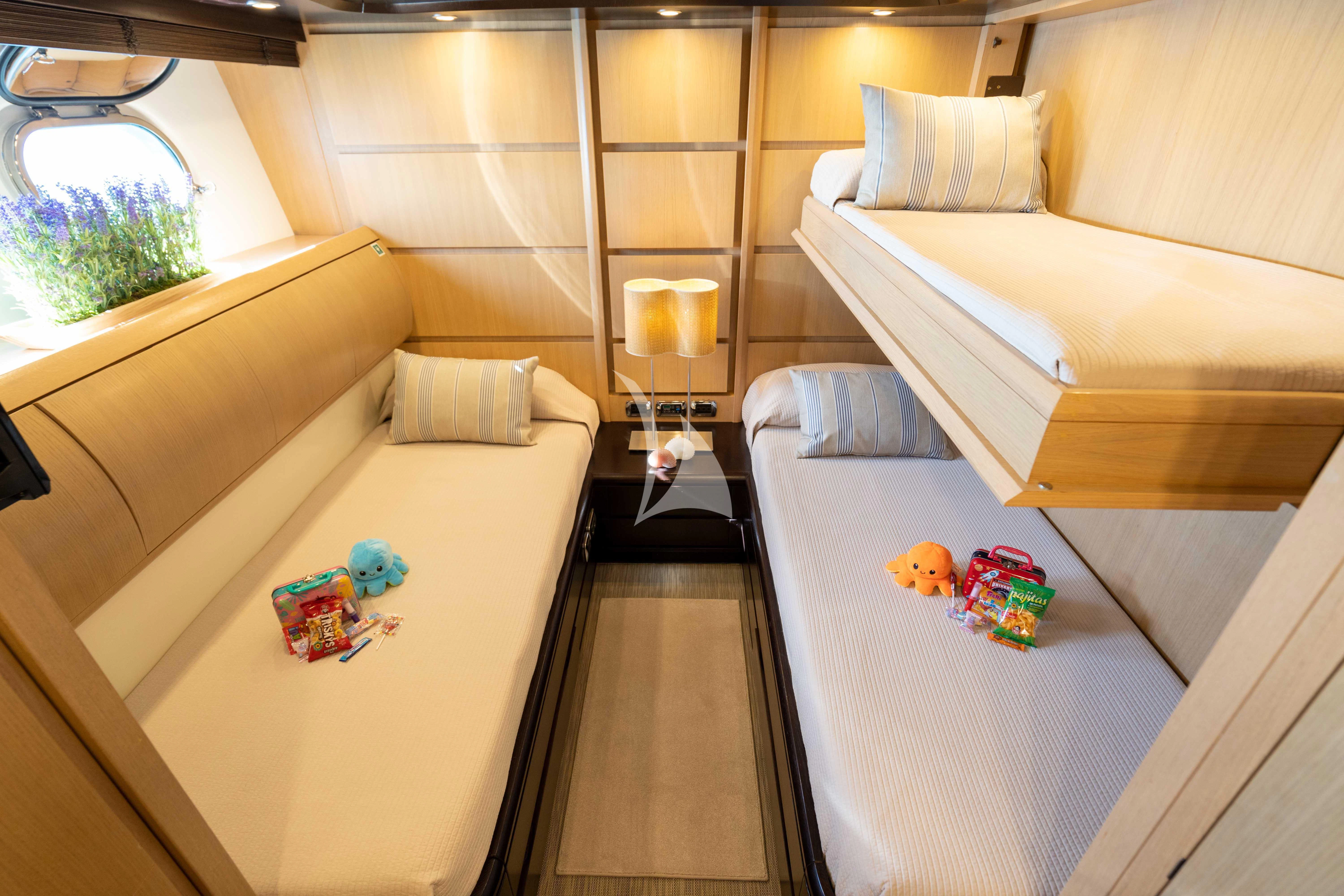 a room with a bed and a table aboard DOLCE VITA IV Yacht for Sale