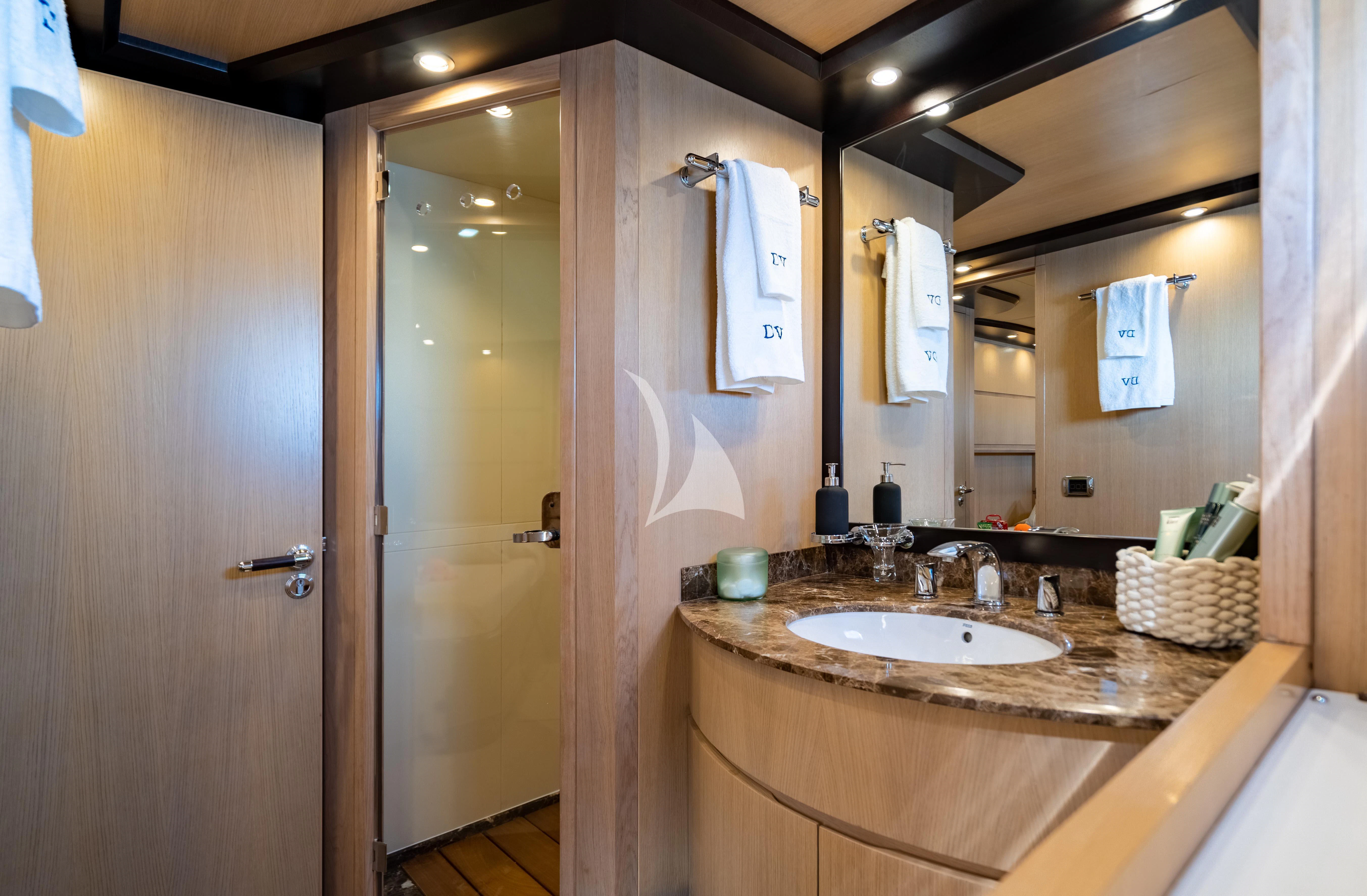 a bathroom with a sink and a mirror aboard DOLCE VITA IV Yacht for Sale