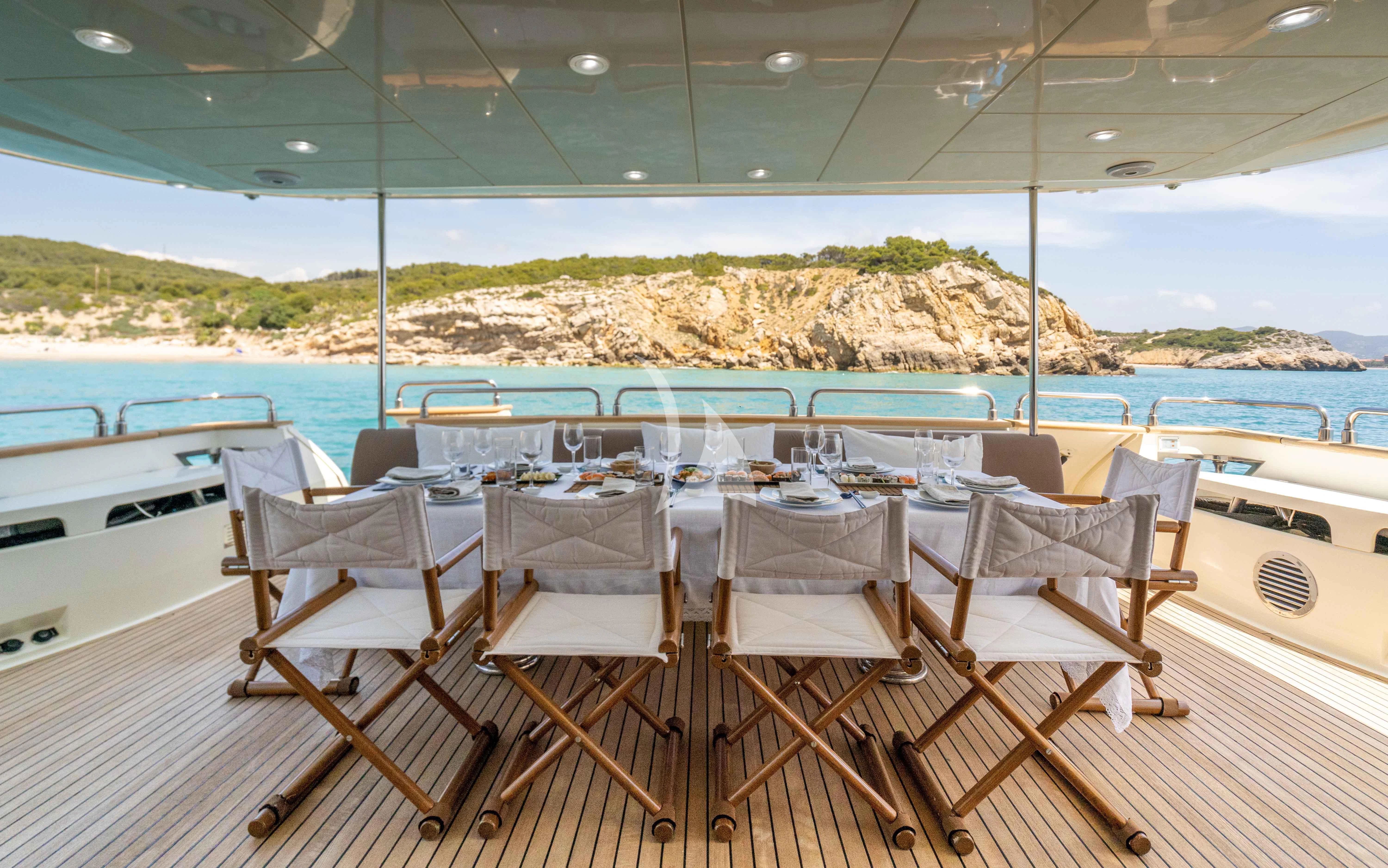 a table set for a dinner on a boat aboard DOLCE VITA IV Yacht for Sale