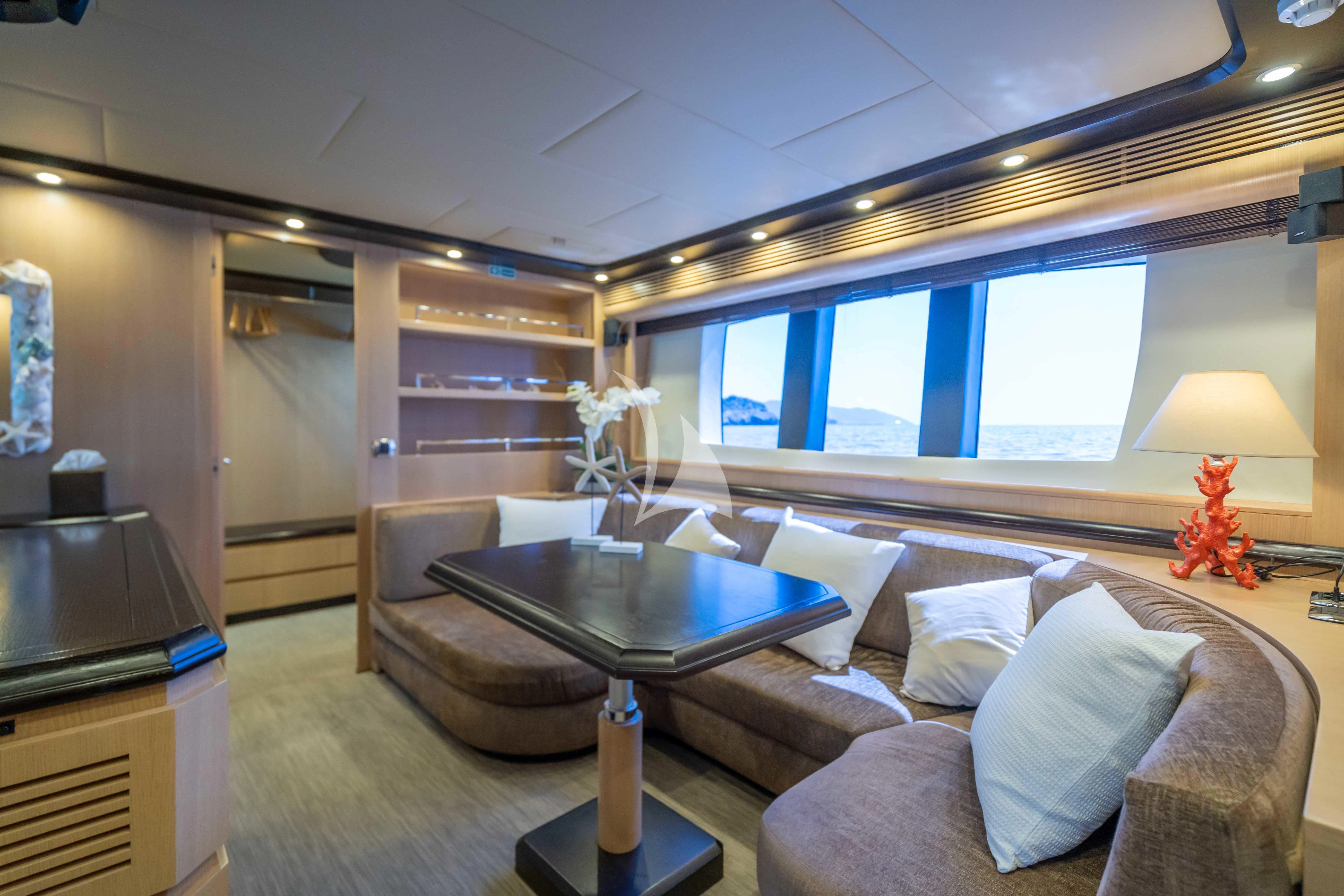 a living room with a couch and a table aboard DOLCE VITA IV Yacht for Sale