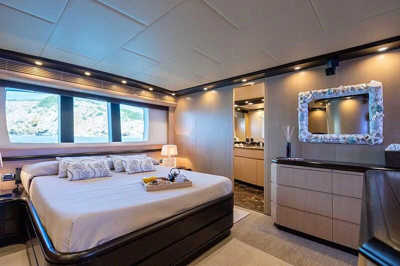 a bedroom with a large mirror aboard DOLCE VITA IV Yacht for Sale